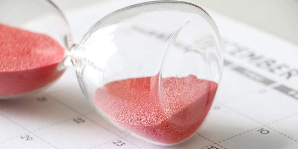 Hourglass with red sand on its side, on calendar, signifying pause, with the words A Short Pause of the Citizenship Clinic, along with the logo of Adoptees United